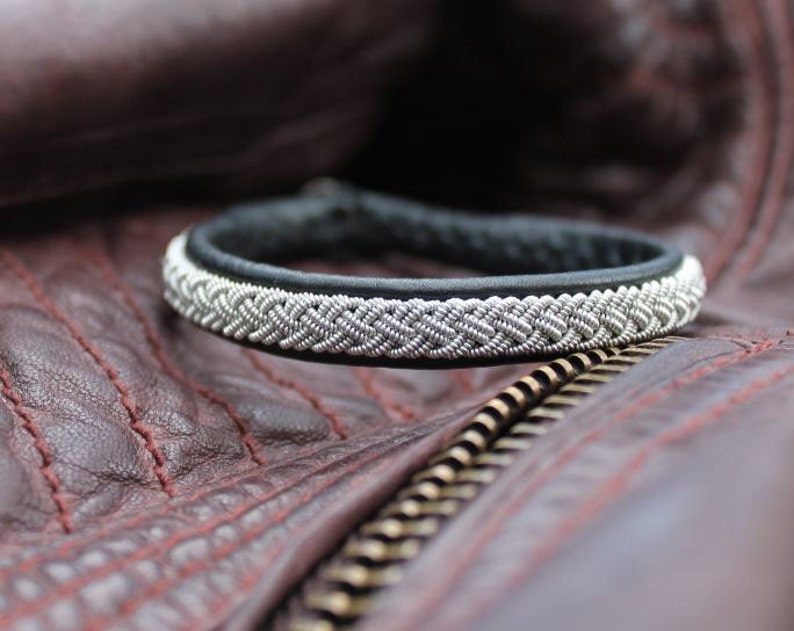 Sami bracelet LEIPT handmade in Black genuine leather and tin wire.
Label AC Design Sweden
Shown on a leather jacket.