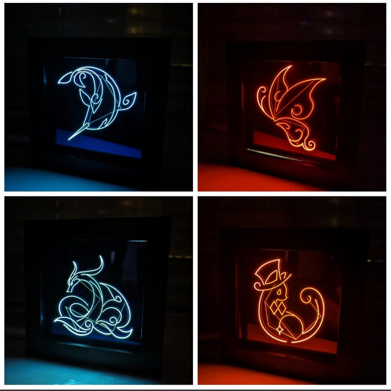 May include: Four framed light-up wall decor pieces. The first piece features a blue dolphin design, the second piece features a red butterfly design, the third piece features a blue dragon design, and the fourth piece features a red cat design wearing a top hat.