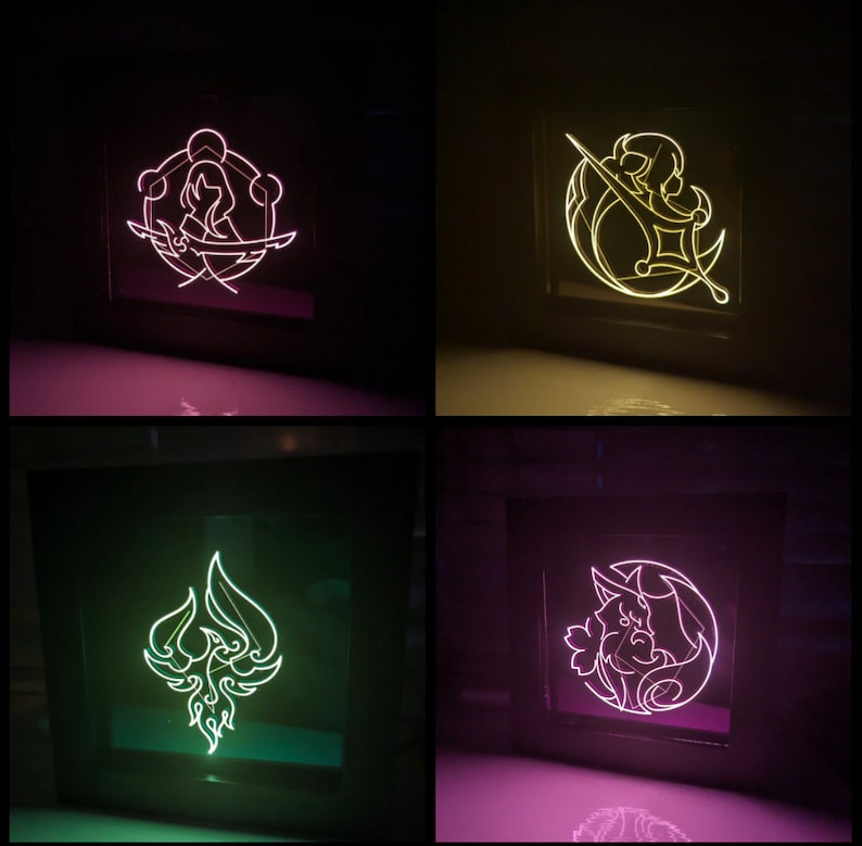 May include: Four different neon signs with various designs. The signs are in black frames and are lit up in different colours. The designs include a woman with a sword, a crescent moon with a sword, a phoenix, and a creature with a crescent moon.