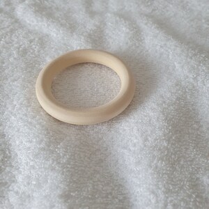 May include: A plain, unfinished wooden ring, ideal for crafting or DIY projects.