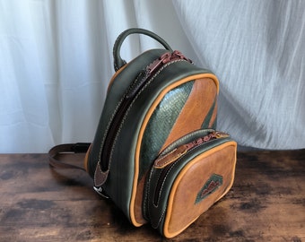 small brown and green leather backpack