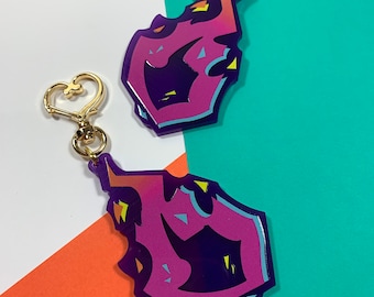 May include: Two purple and pink acrylic keychains with gold heart-shaped clasps. The keychains are shaped like a stylized letter "F" with a jagged, flame-like design.