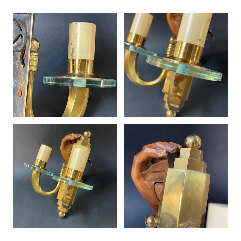 May include: Vintage brass wall sconces. Each sconce has a cylindrical light fixture, a clear glass disc, and a curved brass arm. The sconces have a warm glow and are ideal for adding a touch of vintage charm to any room. The sconces are approximately 20 cm in height.