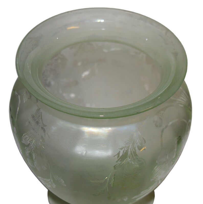 May include: A frosted glass vase with a green iridescent glaze and an etched floral design.