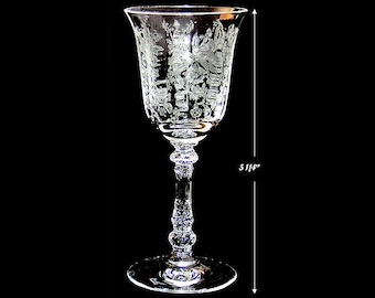 May include: A clear glass wine glass with an etched floral design. The glass is 5 1/4 inches tall.