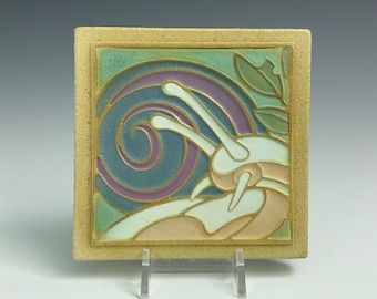 Handmade ceramic art tile, snail in a garden
