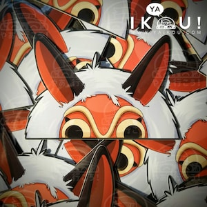 May include: A stack of stickers featuring a red and white cartoon mask with a furry white trim. The mask has large, round eyes and a wide, open mouth. The stickers are printed with the text "IKOU!" and a website address.