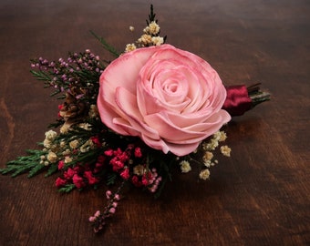 Woodland Groom's boutonniere with pink sola rose, preserved green thuja, heather, pink baby's breath and tiny cones