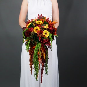 Cascading fall colors wedding bouquet with real preserved flowers and greenery, yellow red green roses sunflowers long amaranth, realistic