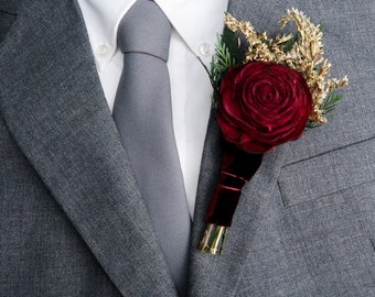 Burgundy rose winter wedding woodland boutonniere with sola flower, gold dried flowers and preserved woodland greenery