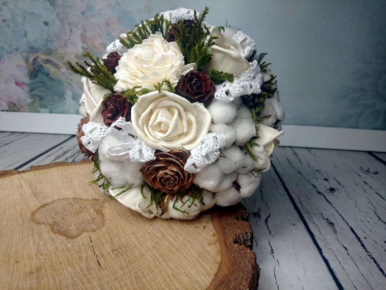 Natural wedding bouquet with cotton bolls greenery rustic woodland winter wedding sola flowers and cedar rose