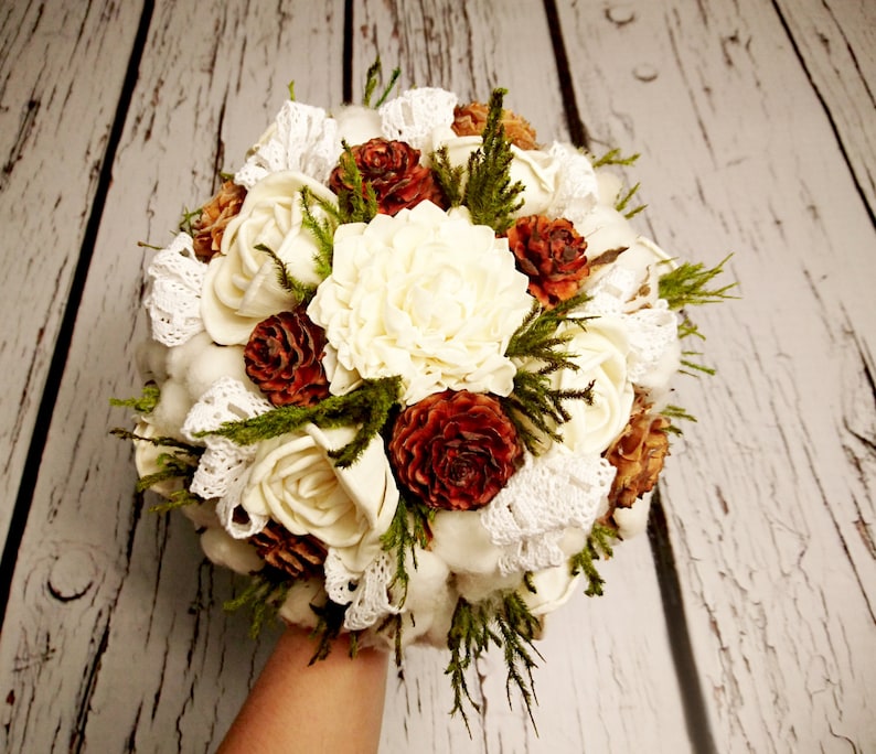Natural wedding bouquet with cotton bolls greenery rustic woodland winter wedding sola flowers and cedar rose