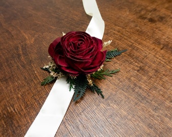 Burgundy rose winter wedding woodland wrist corsage with sola flower, gold dried flowers and preserved woodland greenery