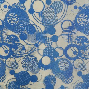 May include: Abstract pattern featuring blue circles, dots, and various textures on a white background. The design includes concentric circles, dotted patterns, and a leopard print-like texture, creating a dynamic and visually engaging composition.