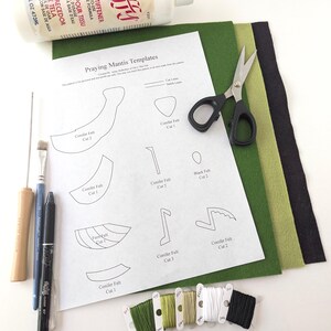 May include: Craft supplies for a DIY project, including a bottle of fabric stiffener, scissors, felt sheets in green and black, embroidery floss, and a printed template labeled "Praying Mantis Templates."