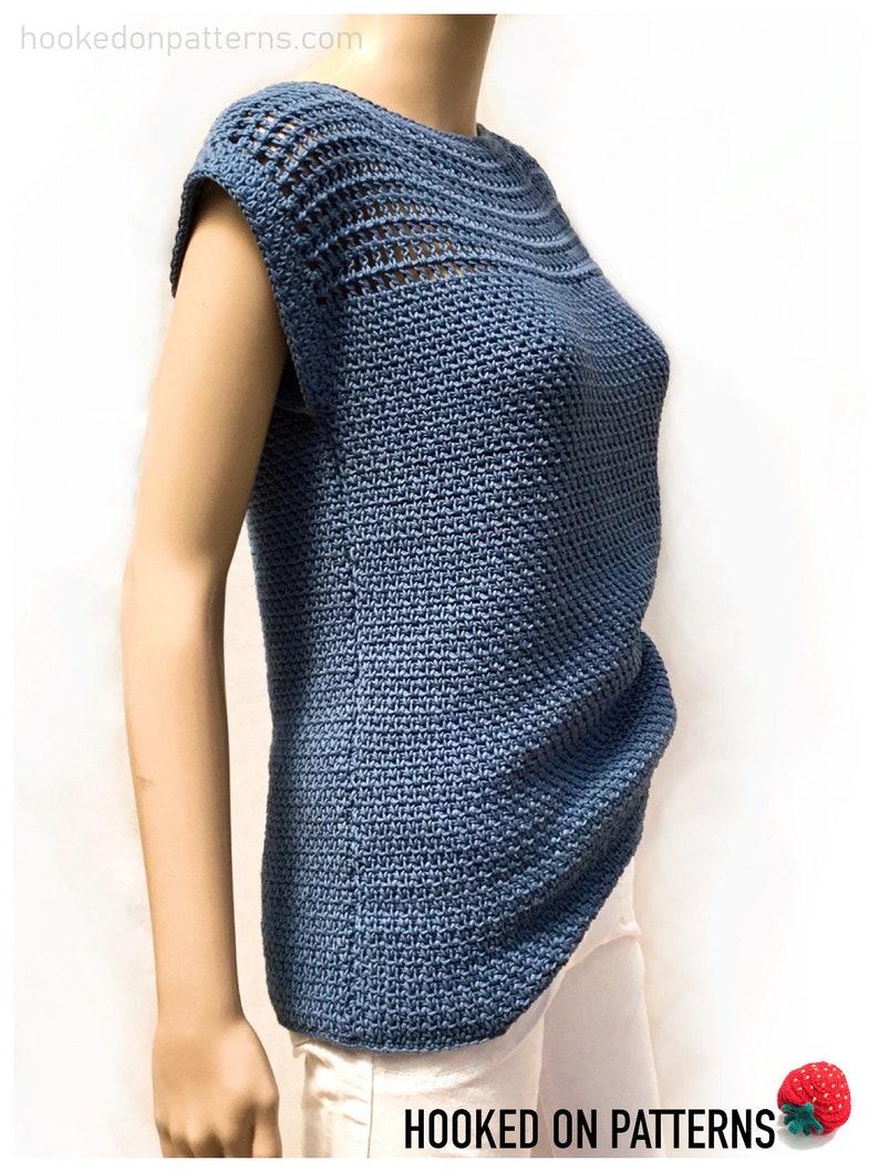 May include: A blue crochet top with a crocheted neckline and short sleeves. The top is made with a stitch pattern that creates a textured look.