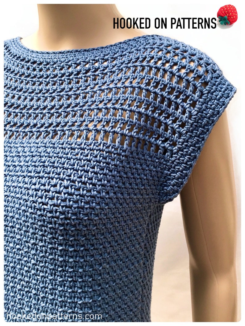 May include: A blue crochet top with a lacy, open-stitch design. The top has a round neckline and short sleeves. The text "HOOKED ON PATTERNS" is visible at the top of the image.