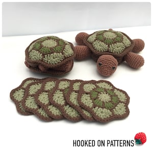 May include: A set of crocheted turtle coasters in brown and green. The set includes a larger turtle with a shell that can be used as a storage container. The text "HOOKED ON PATTERNS" is visible in the image.