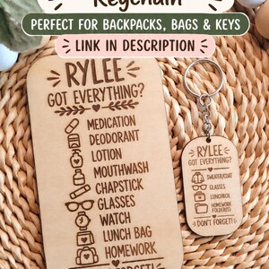 May include: A rectangular wooden checklist sign and a matching wooden keychain, both engraved with the name Rylee and a list of items including medication, deodorant, lotion, mouthwash, chapstick, glasses, watch, lunch bag, homework, and don't forget.