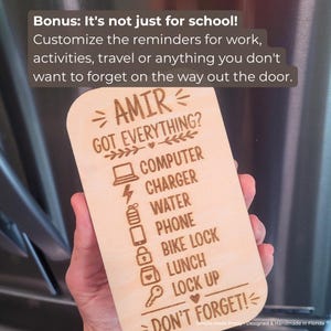 May include: A light-colored wooden checklist sign with rounded corners featuring laser-engraved text: AMIR GOT EVERYTHING? COMPUTER, CHARGER, WATER, PHONE, BIKE LOCK, LUNCH, LOCK UP, DON'T FORGET! and icons for each item, plus additional text about customization.