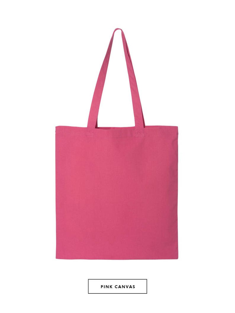 May include: A pink canvas tote bag with two handles. The bag is empty and ready to be filled with items.