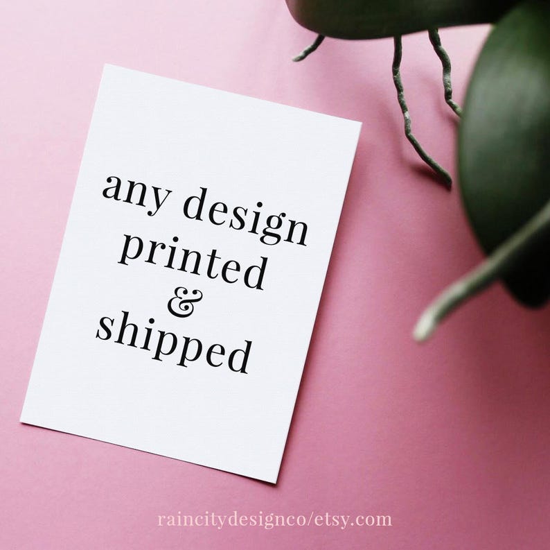 May include: White card with black text that reads "any design printed & shipped" on a pink background. The text is centered on the card.