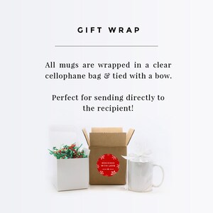 May include: A white mug wrapped in a clear cellophane bag and tied with a bow. The mug is sitting on a white surface next to a brown box with a red sticker that says "Designed with Love".