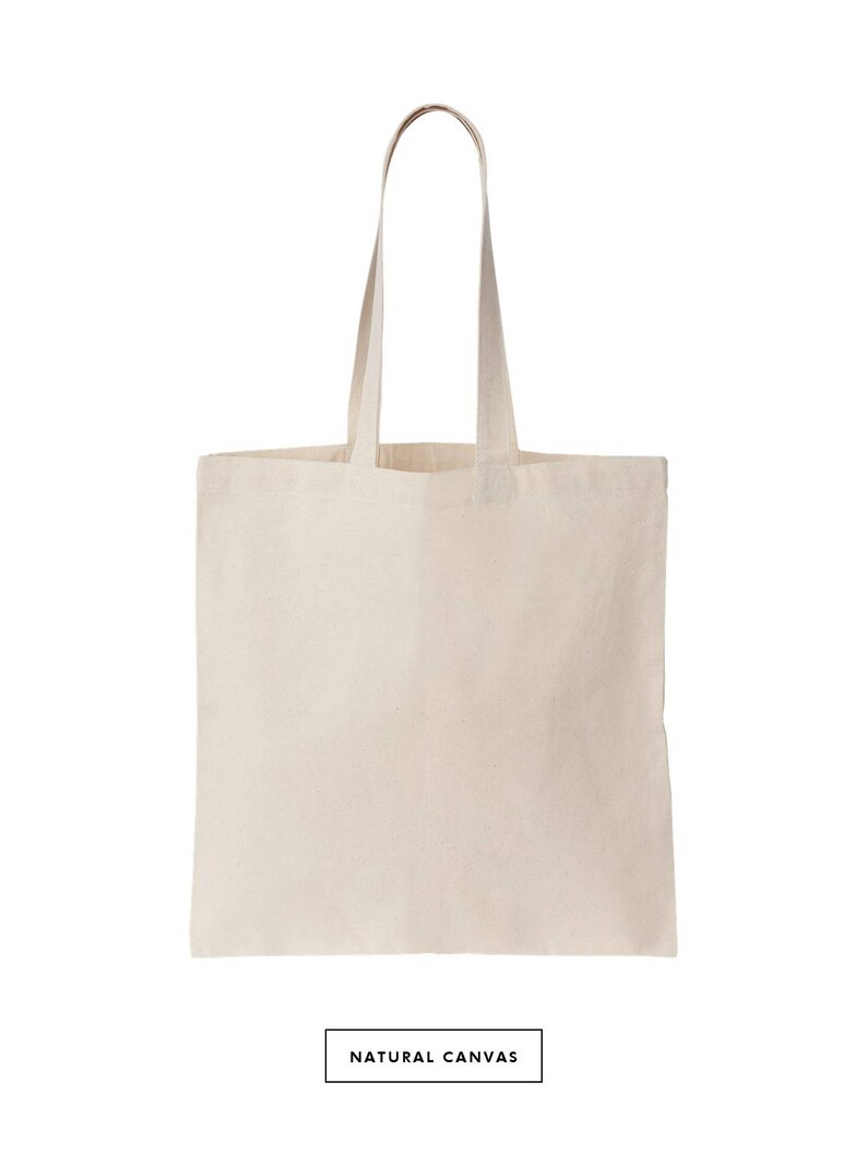 May include: A natural canvas tote bag with two long handles. The bag is empty and has a white background.