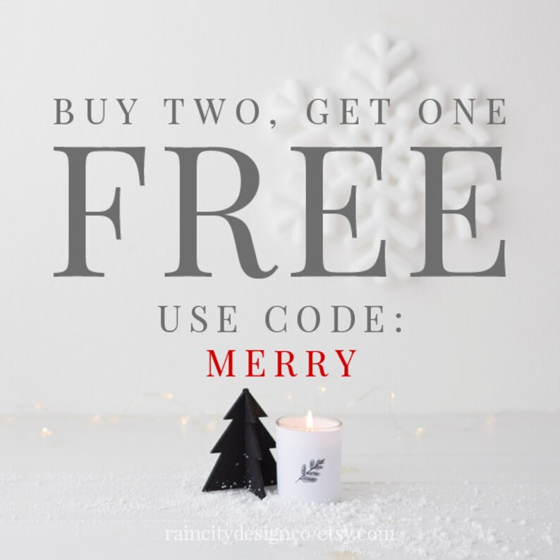 May include: Buy two, get one free. Use code: MERRY. A white candle with a black tree silhouette on a white surface with snow.