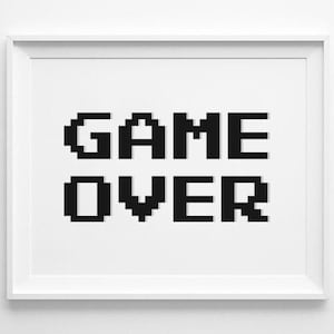 May include: A white framed print with the words "GAME OVER" in black pixelated letters.