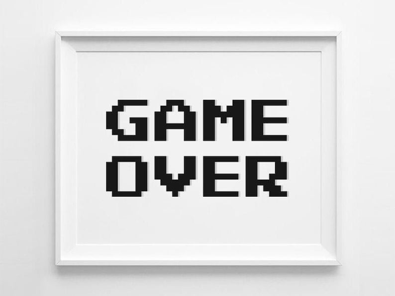 May include: A white framed print with the words "GAME OVER" in black pixelated letters.