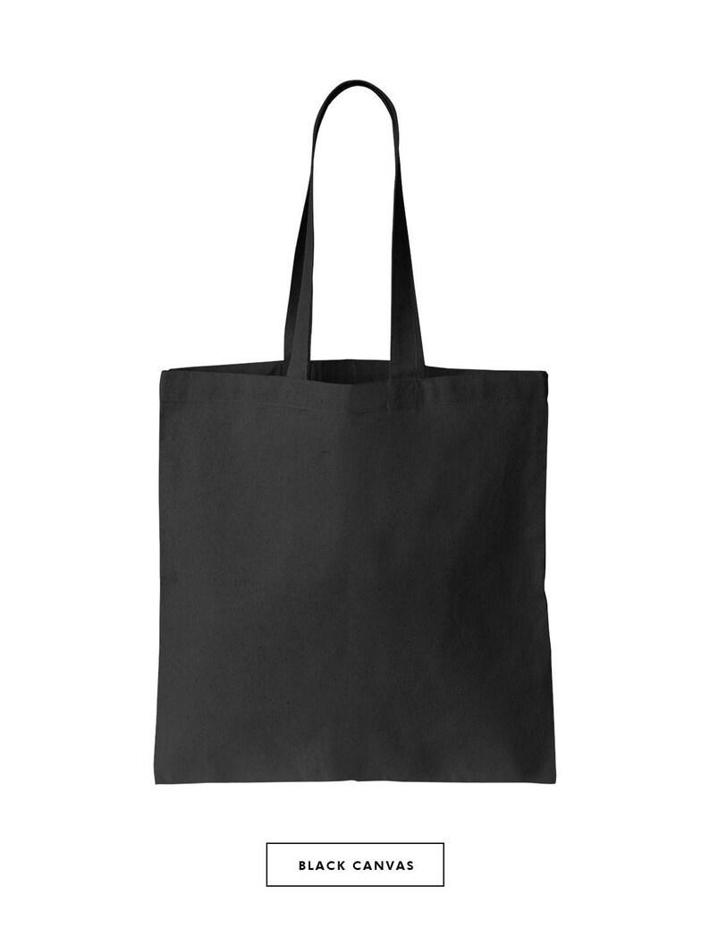 May include: A black canvas tote bag with two handles. The bag is empty and has a flat bottom.