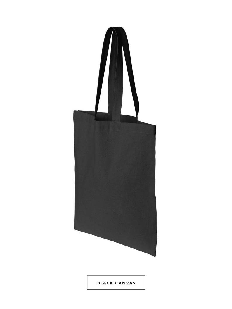May include: A black canvas tote bag with black handles. The bag is empty.