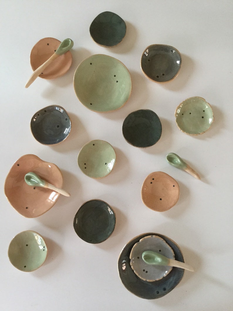 Four tiny stacking plates with spoon