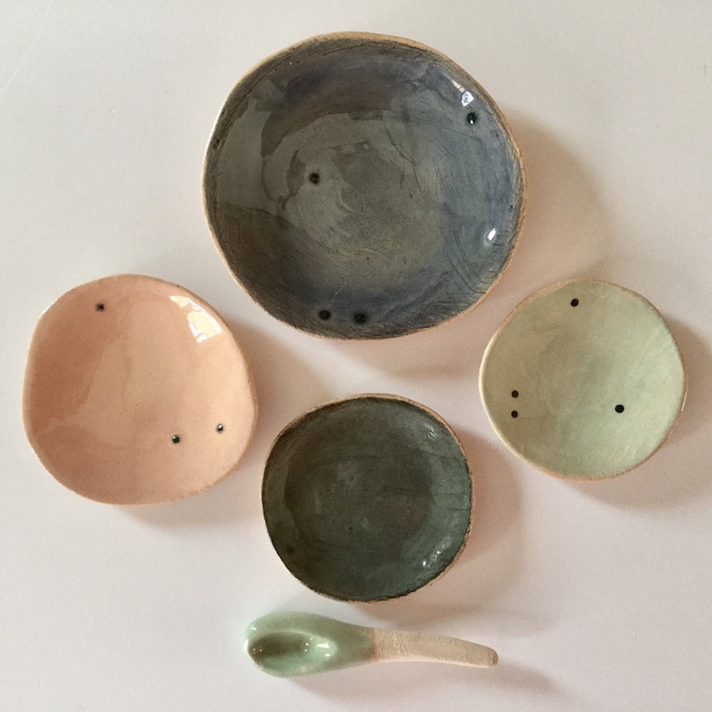 Four tiny stacking plates with spoon