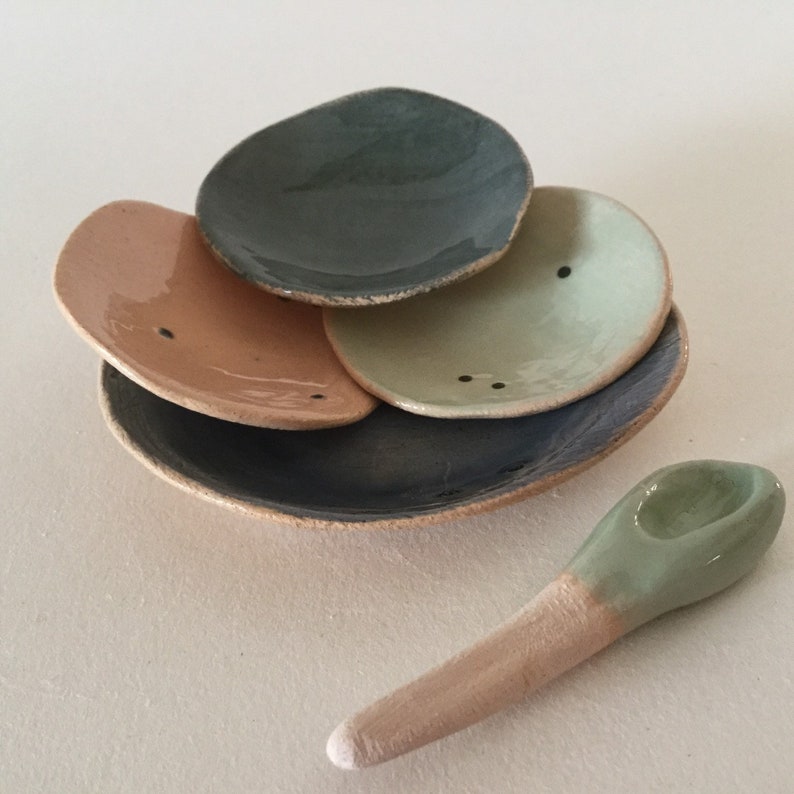 Four tiny stacking plates with spoon