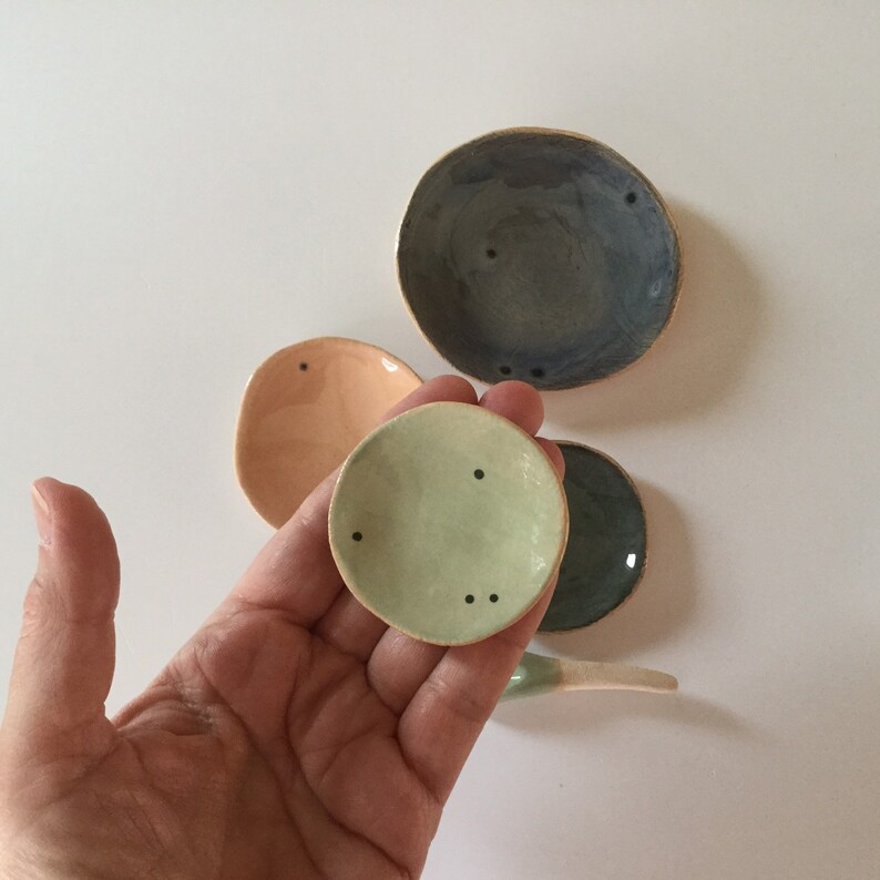 Four tiny stacking plates with spoon