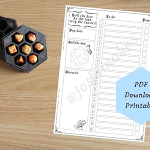 May include: A black hexagonal wooden dice box containing six orange and white marbled polyhedral dice, positioned next to a white paper task tracker sheet featuring the text Roll the dice, do the task, reap the reward, To do, Done, Day/date, Roll the dice, Rewards, and PDF Download Printable.