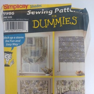 May include: A Simplicity Sewing Pattern for Dummies, pattern number 9986, for making window shades. The pattern includes four different styles of shades, including a roman shade, a valance, and a layered shade. The pattern is for one size and is titled "Stitch up a storm the Fun and Easy Way."