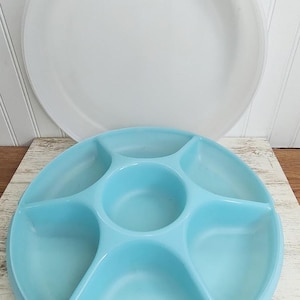 May include: A light blue plastic serving tray with five sections and a clear plastic lid. The tray is perfect for serving snacks, dips, or appetizers.