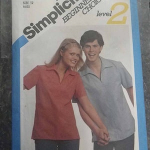 May include: Simplicity sewing pattern number 5226, Beginner's Choice level 2, for a shirt. The pattern shows a woman and a man wearing the shirt in red and blue.