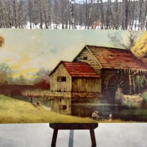 May include: A vintage painting of a rustic wooden watermill with a red roof, surrounded by trees and a pond. Two figures are fishing in the pond, and a bridge is visible in the background.