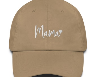 May include: A tan baseball cap with the word "Mama" embroidered in white script across the front. A small white heart is next to the word "Mama". The cap has a curved brim and an adjustable strap.