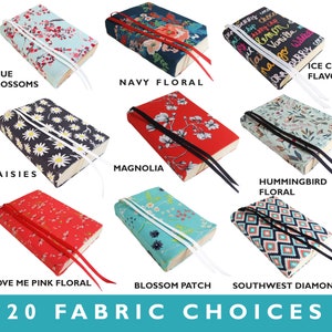 May include: Twenty fabric choices for book covers, including floral patterns, geometric designs, and a pattern with ice cream flavors. The fabric choices are displayed on a white background.