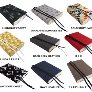 May include: Nine different book covers with various patterns and colors. The covers include a midnight forest design, airplane silhouettes, bold southwest pattern, pineapples, dark grey heather, red, black and white southwest, navy heather, and elephant.