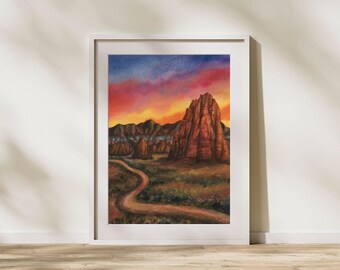 May include: A watercolor painting of a red rock formation in a desert landscape. The sky is a vibrant mix of pink, orange, and purple, suggesting a sunset. A winding dirt road leads towards the rock formation.