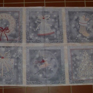 May include: A white fabric panel with six squares, each featuring a different Christmas design. The designs include a wreath, a bell, a stocking, a gift, a reindeer, and a Christmas tree. The designs are embroidered in white and red thread on a grey background.