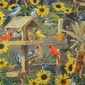 Patchwork fabric birdhouses in a sunflower field