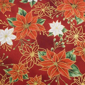 May include: A festive fabric featuring a repeating pattern of red poinsettias with gold outlines and accents. Green leaves and white poinsettias are interspersed on a deep red background, creating a holiday theme.