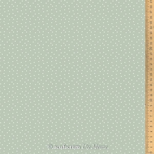 May include: A light green fabric with a white polka dot pattern. The fabric is shown with a ruler measuring 76 cm.